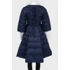 The dark blue jacket is flared up