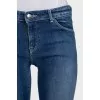 Skinny blue jeans with a logo on the pocket