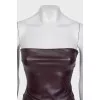 A suit consisting of a crop top and straight-leg trousers