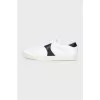 Sneakers with black inserts and a tag