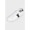Sneakers with black inserts and a tag