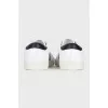 Sneakers with black inserts and a tag