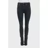 Mid-rise tapered jeans with zippers at the bottom