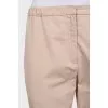 Tapered trousers with elastic