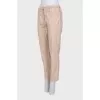 Tapered trousers with elastic