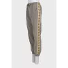 Brown sweatpants with a signature print