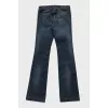 Blue flared jeans with a chain on the pocket