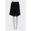 Pleated skirt decorated with lace