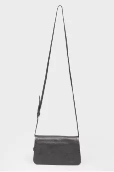 Black leather handbag on a zipper and button