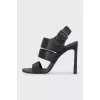 Black leather sandals with a decorated strap