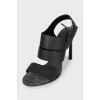 Black leather sandals with a decorated strap