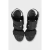 Black leather sandals with a decorated strap