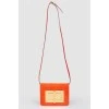 Red leather bag with gold-tone metal hardware