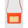 Red leather bag with gold-tone metal hardware