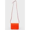 Red leather bag with gold-tone metal hardware