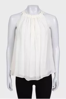 White pleated sleeveless blouse