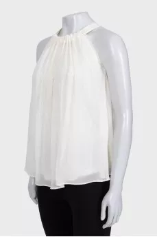 White pleated sleeveless blouse