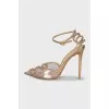 Golden slingbacks decorated with rhinestones