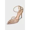 Golden slingbacks decorated with rhinestones