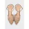 Golden slingbacks decorated with rhinestones