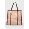 Brown bag with leather inserts, on the handles