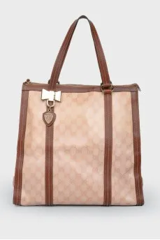 Brown bag with leather inserts, on the handles