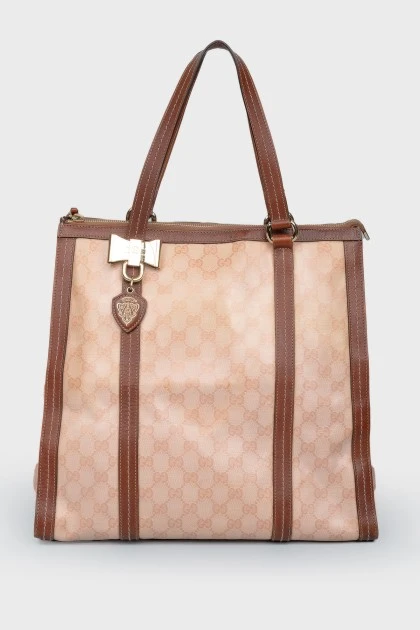 Brown bag with leather inserts, on the handles