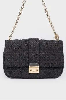 Black leather handbag on a golden chain