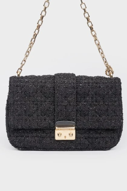Black leather handbag on a golden chain