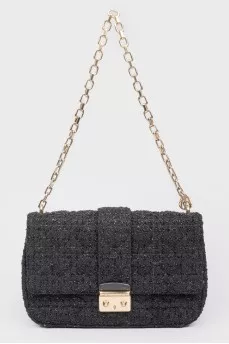 Black leather handbag on a golden chain