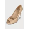 Beige leather shoes with decorated heels