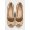 Beige leather shoes with decorated heels