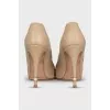 Beige leather shoes with decorated heels