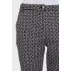 Tapered black trousers with a print