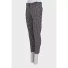 Tapered black trousers with a print