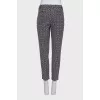 Tapered black trousers with a print