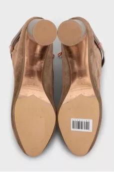 Brown suede ankle boots with a zipper