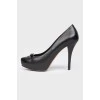 Black leather shoes with stiletto heels
