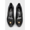 Black leather shoes with stiletto heels
