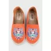Orange moccasins with embroidery