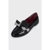 Black leather loafers decorated with a bow