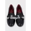 Black leather loafers decorated with a bow