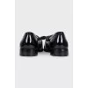 Black leather loafers decorated with a bow