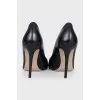 Black leather pumps