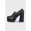 Black leather shoes with chunky heels