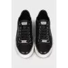 Black leather sneakers with silver logo