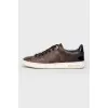 Sneakers in the print of the log of brand