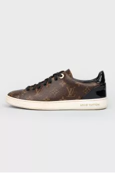Sneakers in the print of the log of brand