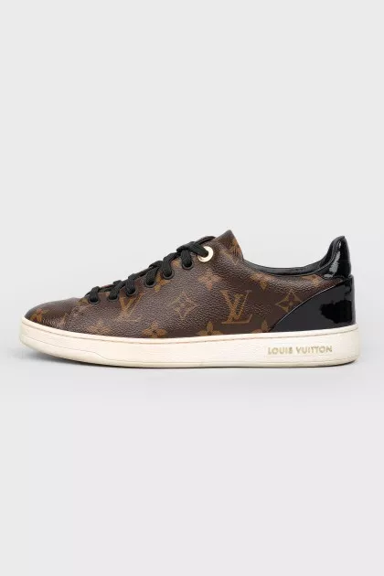 Sneakers in the print of the log of brand