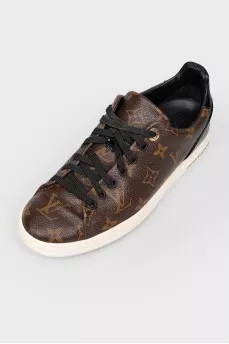 Sneakers in the print of the log of brand